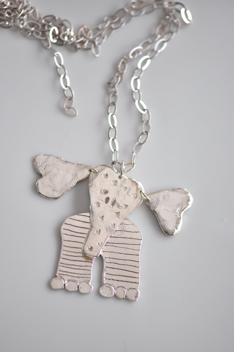 Handmade sterling silver articulated elephant necklace with textured sculptural design, whimsical animal jewelry