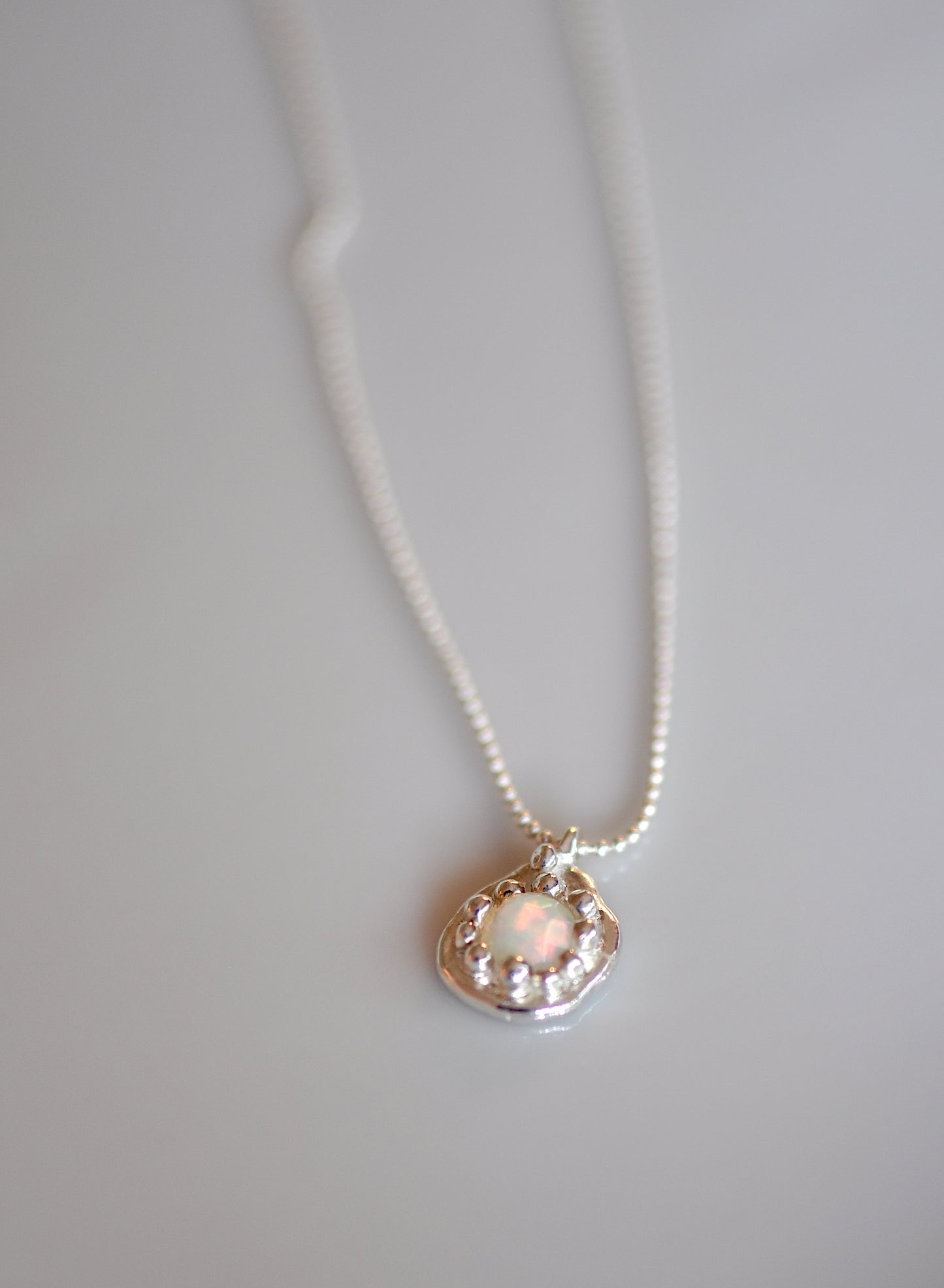 dainty flower charm with opal