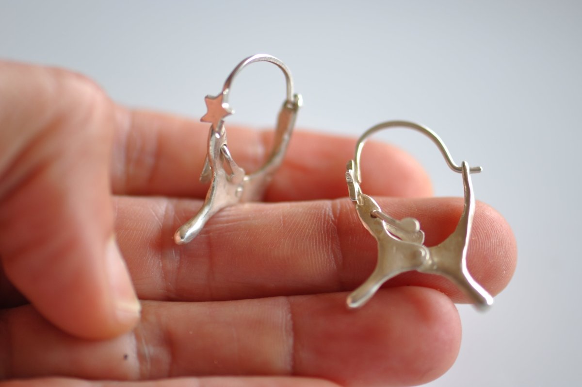 Handmade sterling silver dog shaped hoop earrings with articulated moving ears, made in Barcelona