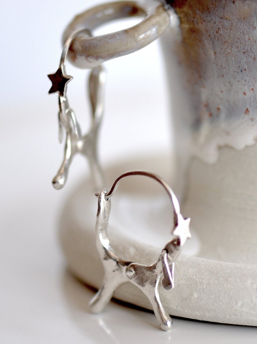 Handmade sterling silver dog shaped hoop earrings with articulated moving ears, made in Barcelona