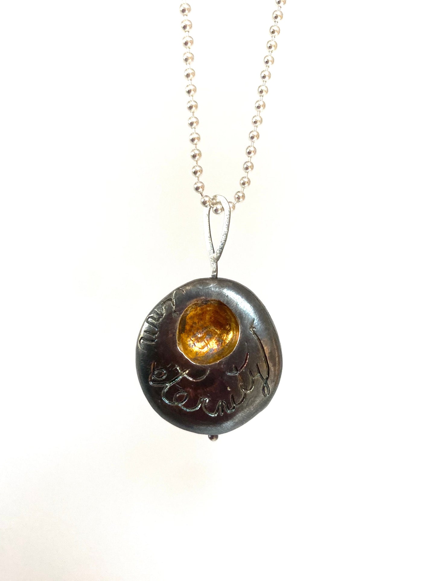 a necklace with a pendant that has a picture on it