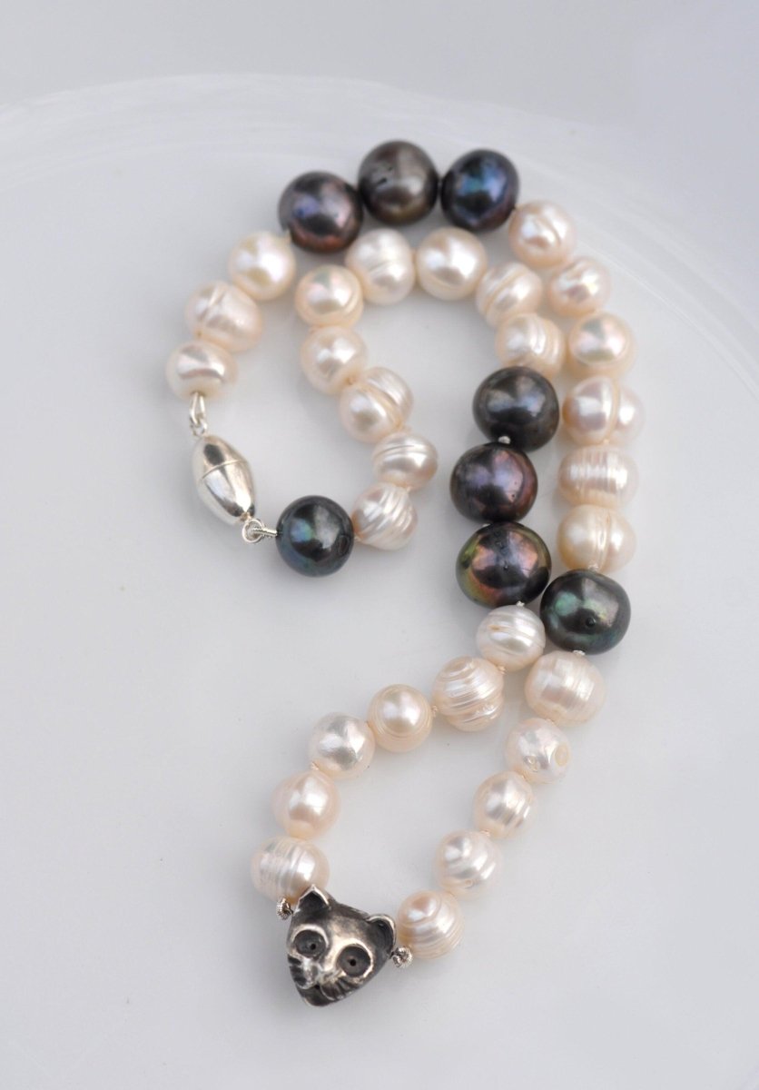 Handmade black and white freshwater pearl necklace with sterling silver cat charm and dark patina, unique cat jewelry