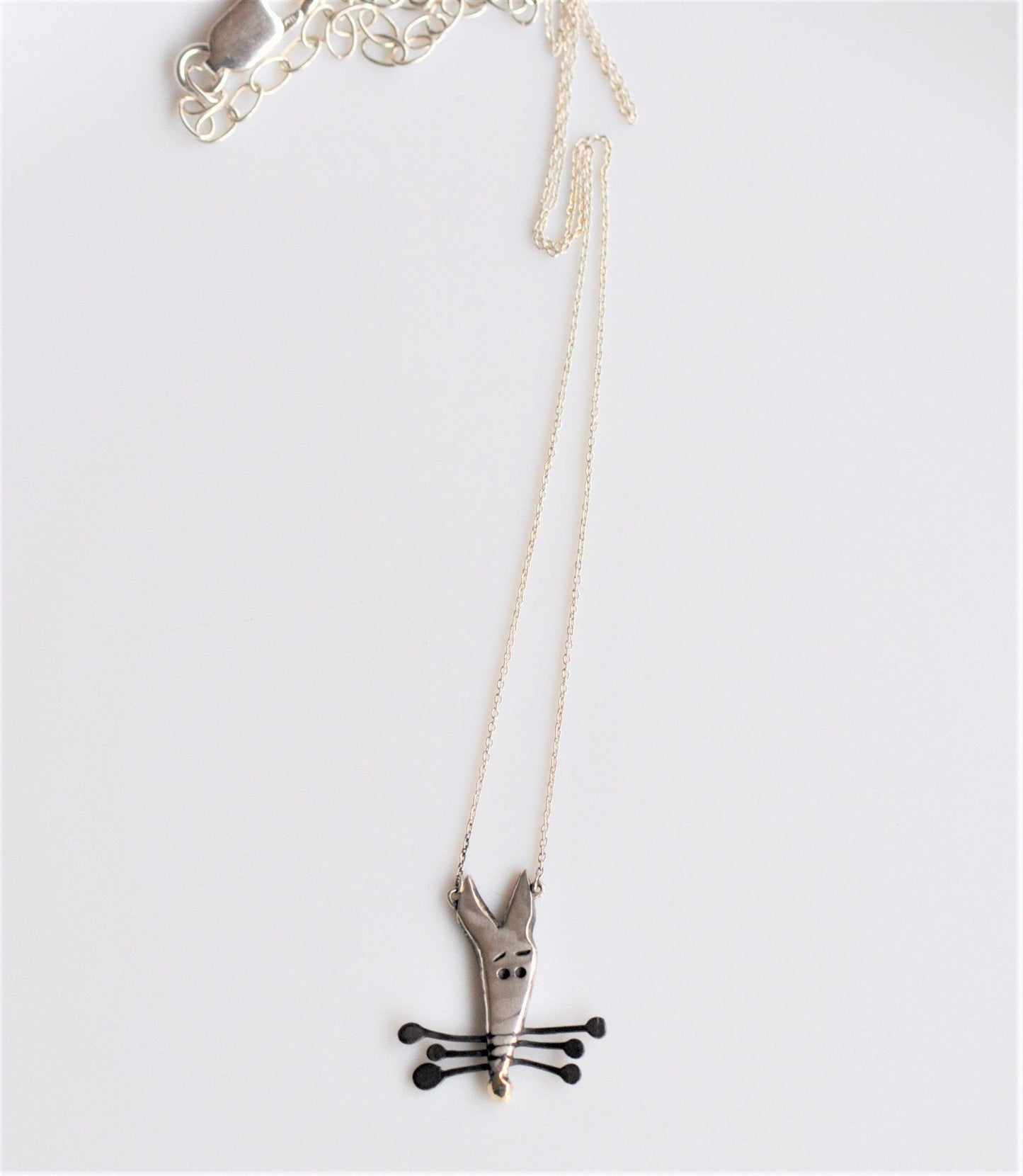 a necklace that has a cat on it