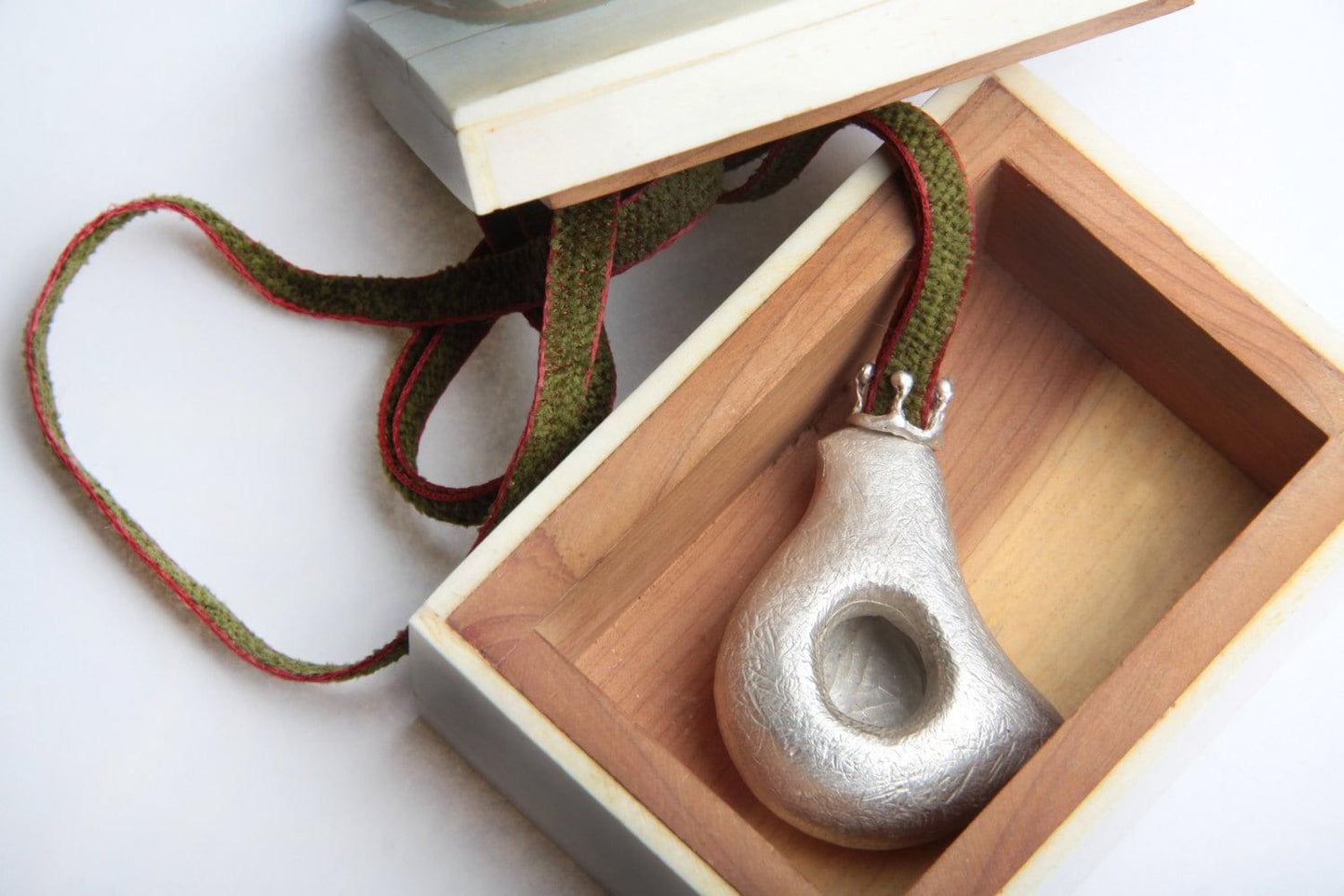 Handmade sterling silver crowned dove pendant necklace with matte texture, on fabric cord, wearable sculpture jewelry