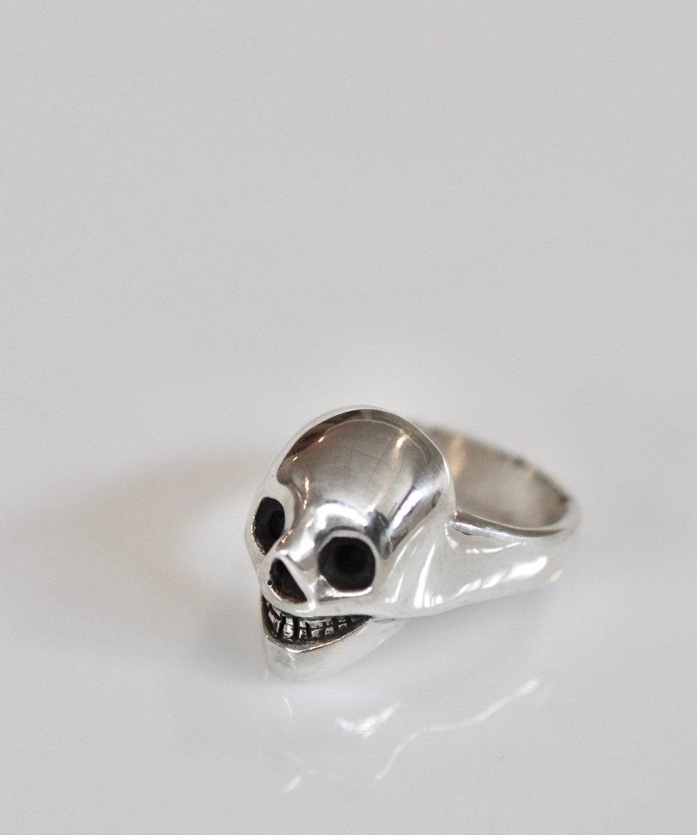 Handmade sterling silver grinning skull ring with polished finish and dark eye sockets, statement ring, made in Barcelona