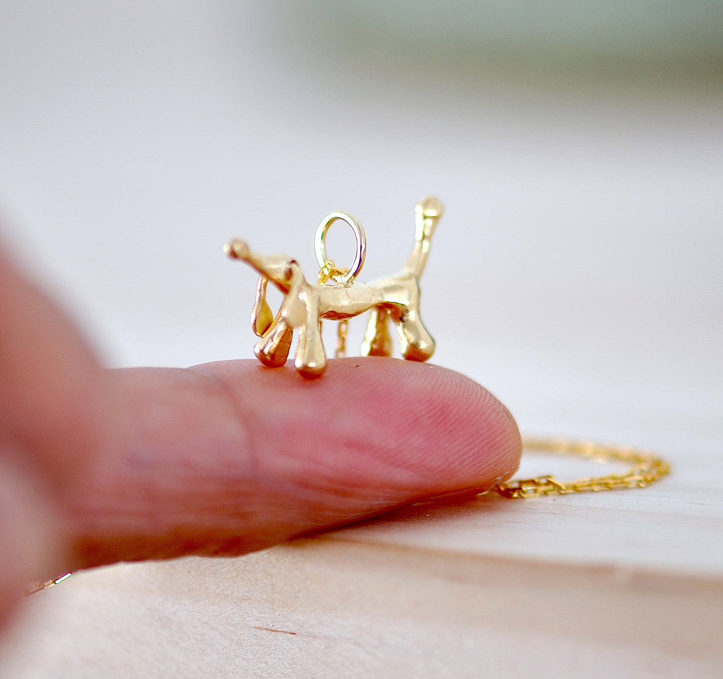 Handmade 14k solid gold dachshund charm necklace with articulated ears, made in Barcelona
