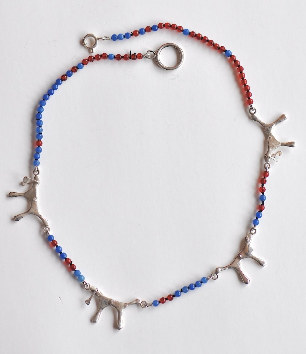 Handmade red and blue agate bead necklace with four articulated sterling silver dog charms, made in Barcelona