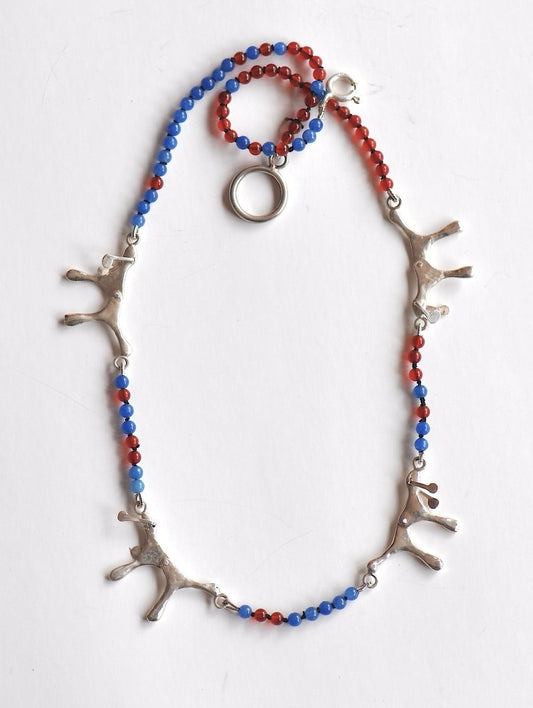 Handmade red and blue agate bead necklace with four articulated sterling silver dog charms, made in Barcelona