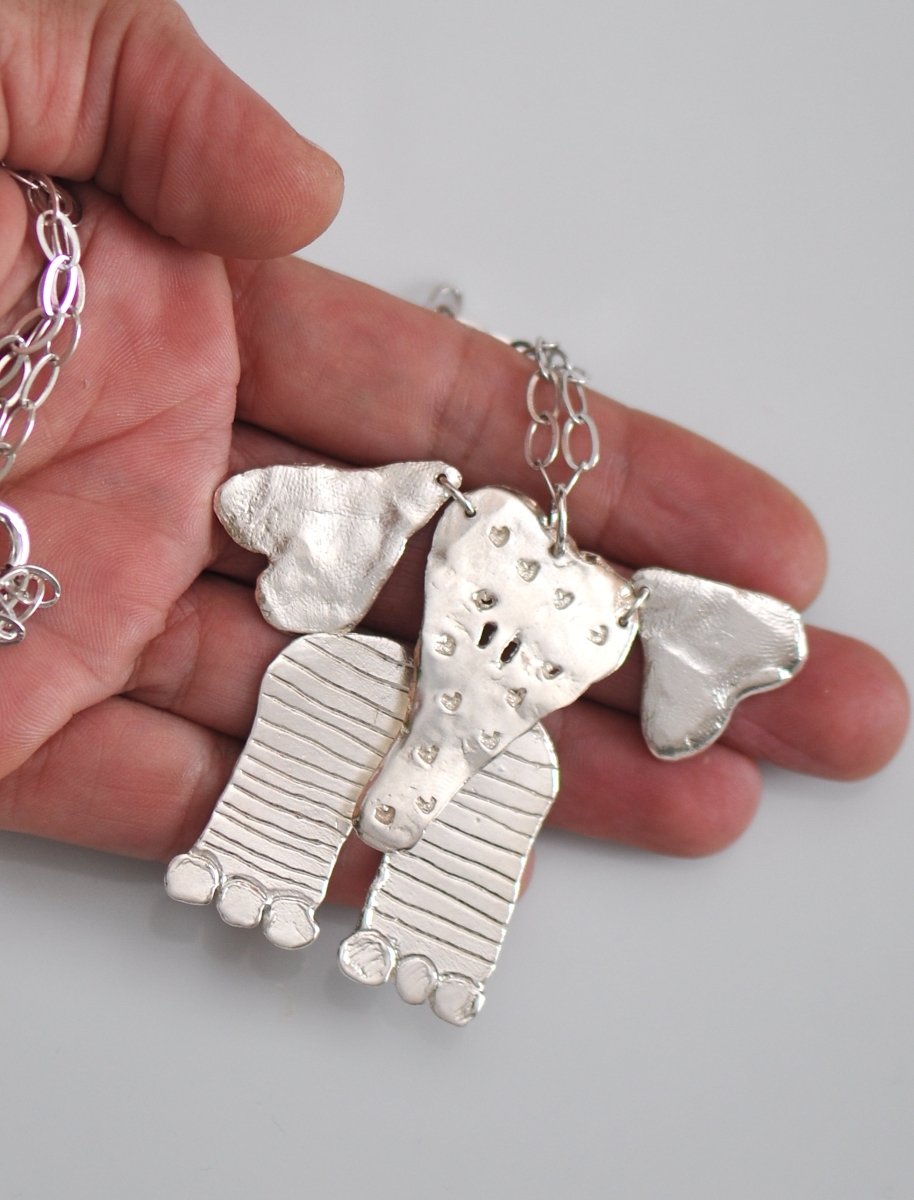 Handmade sterling silver articulated elephant necklace with textured sculptural design, whimsical animal jewelry