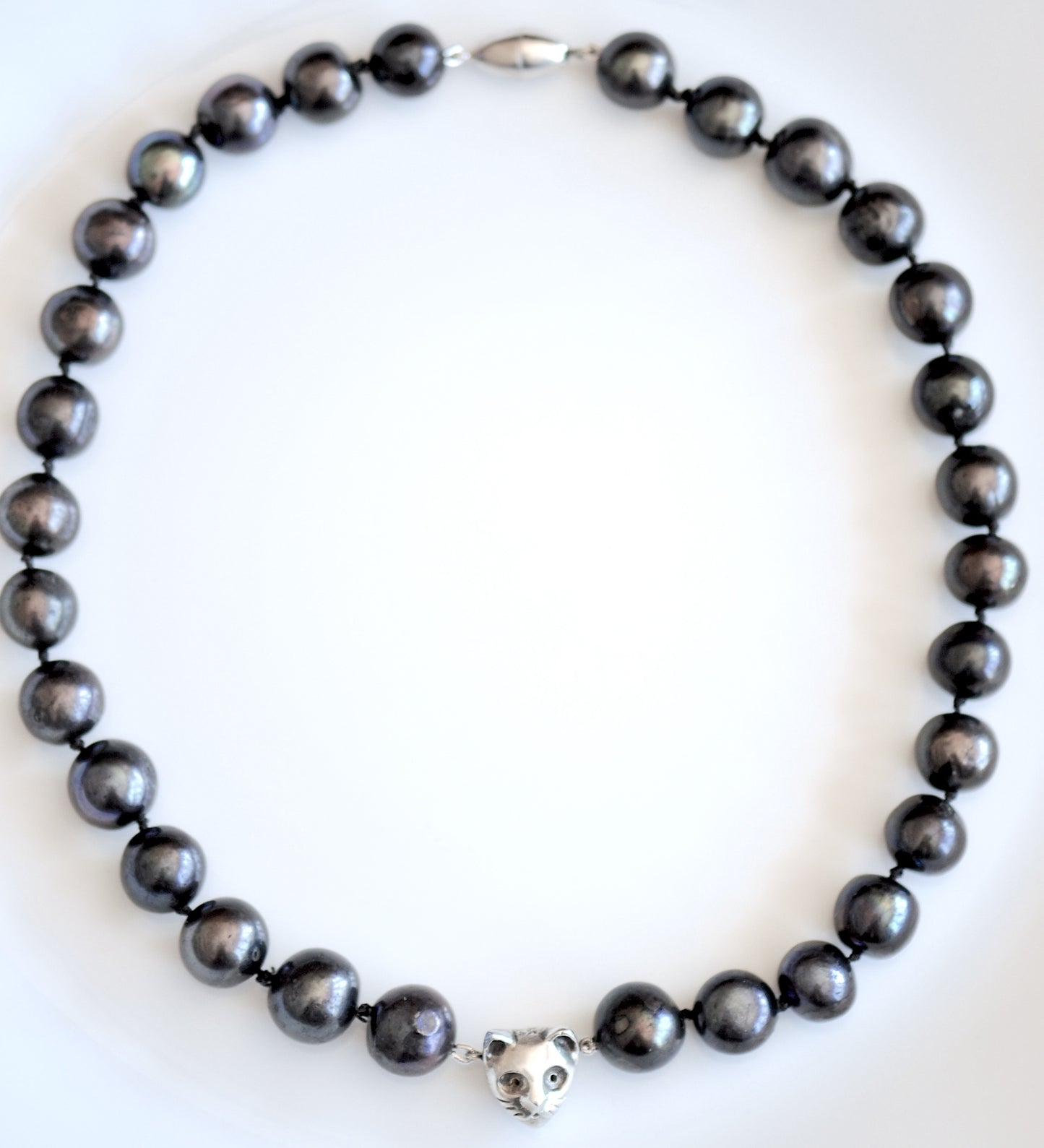 Handmade black freshwater pearl necklace with silver cat charm, made in Barcelona