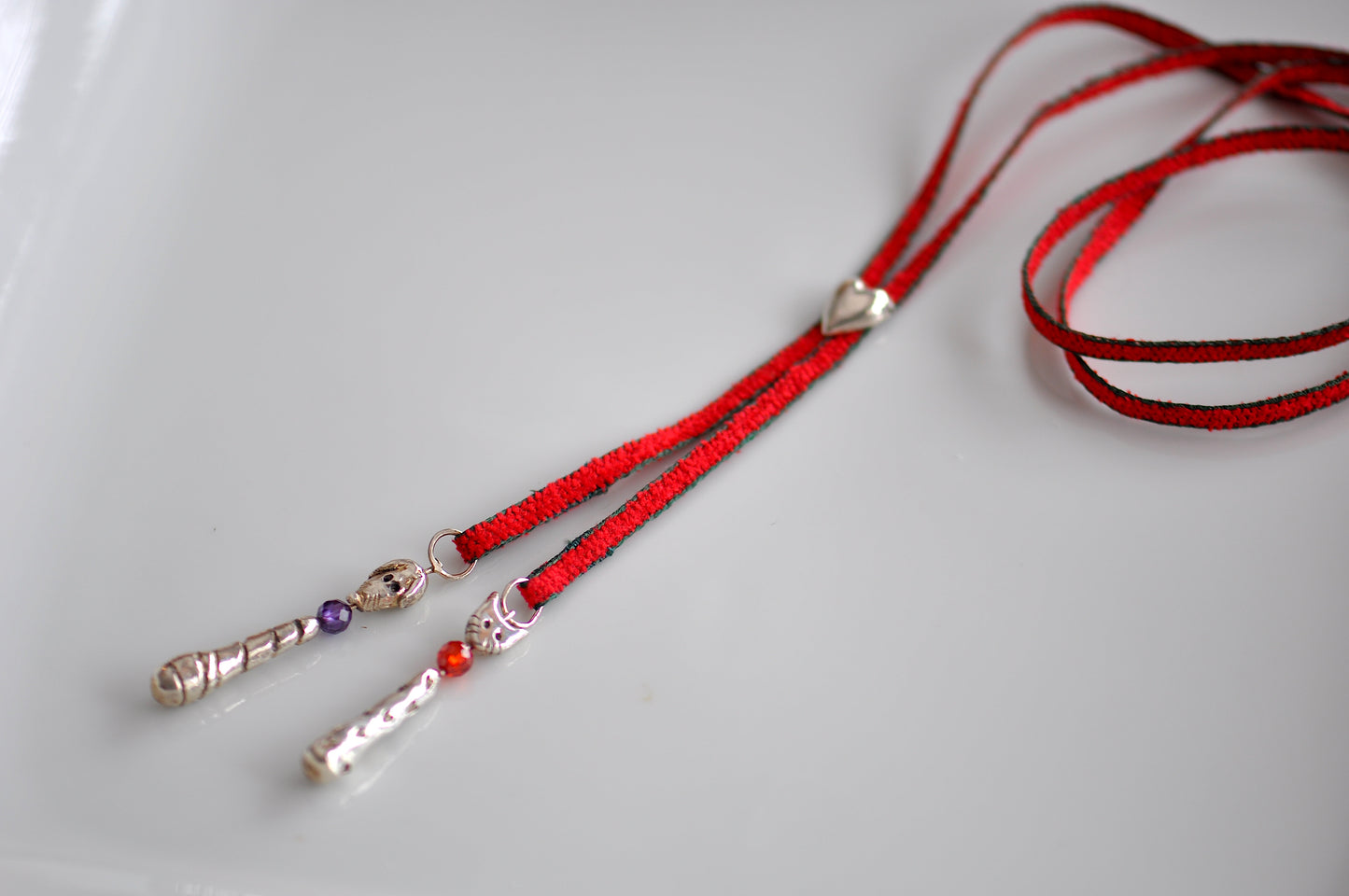 Handmade sterling silver cat and dog charm lariat necklace on red cord with heart clasp and gemstone accents, whimsical animal jewelry