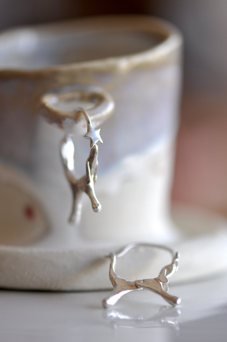 Handmade sterling silver dog shaped hoop earrings with articulated moving ears, made in Barcelona