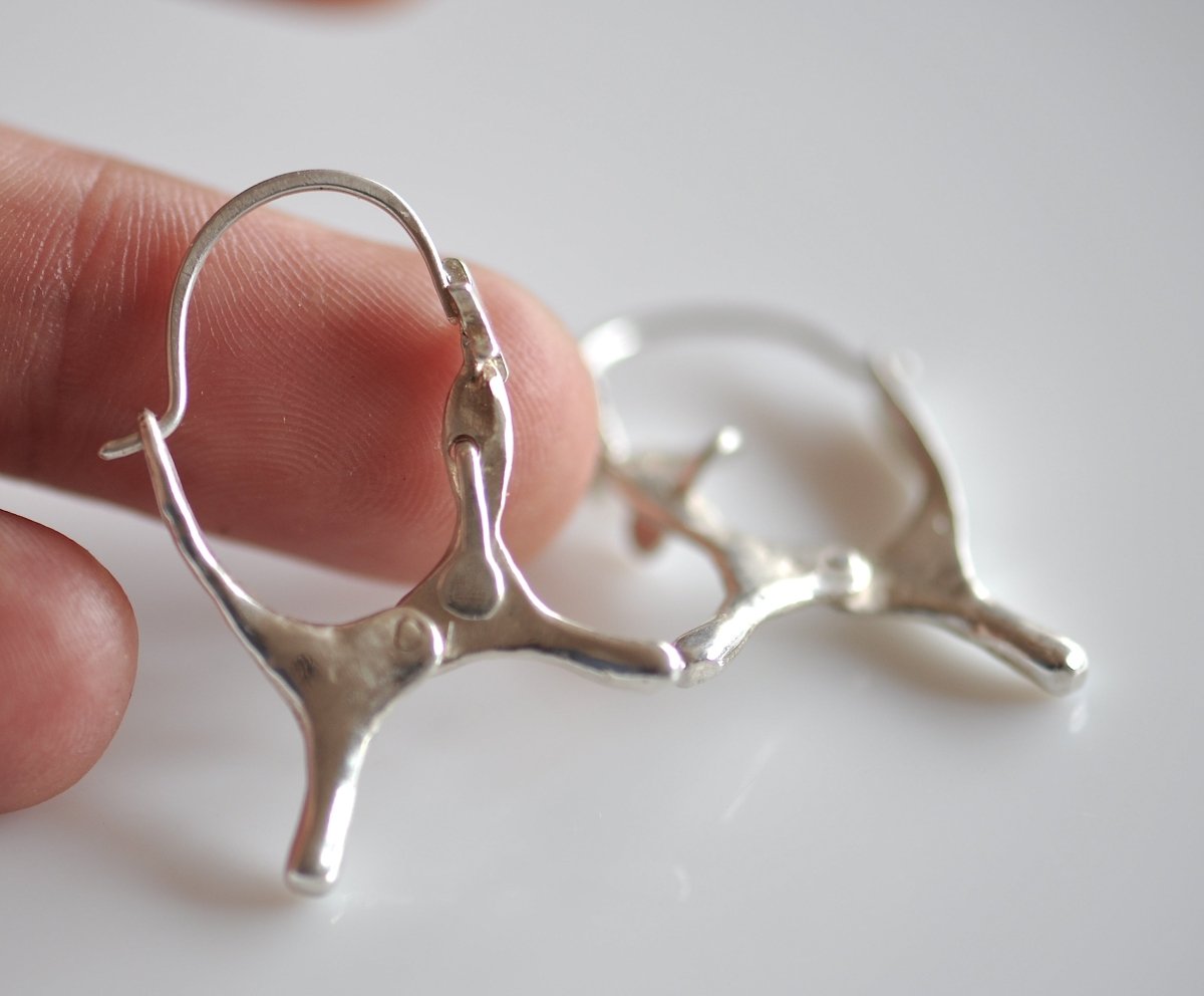 Handmade sterling silver dog shaped hoop earrings with articulated moving ears, made in Barcelona