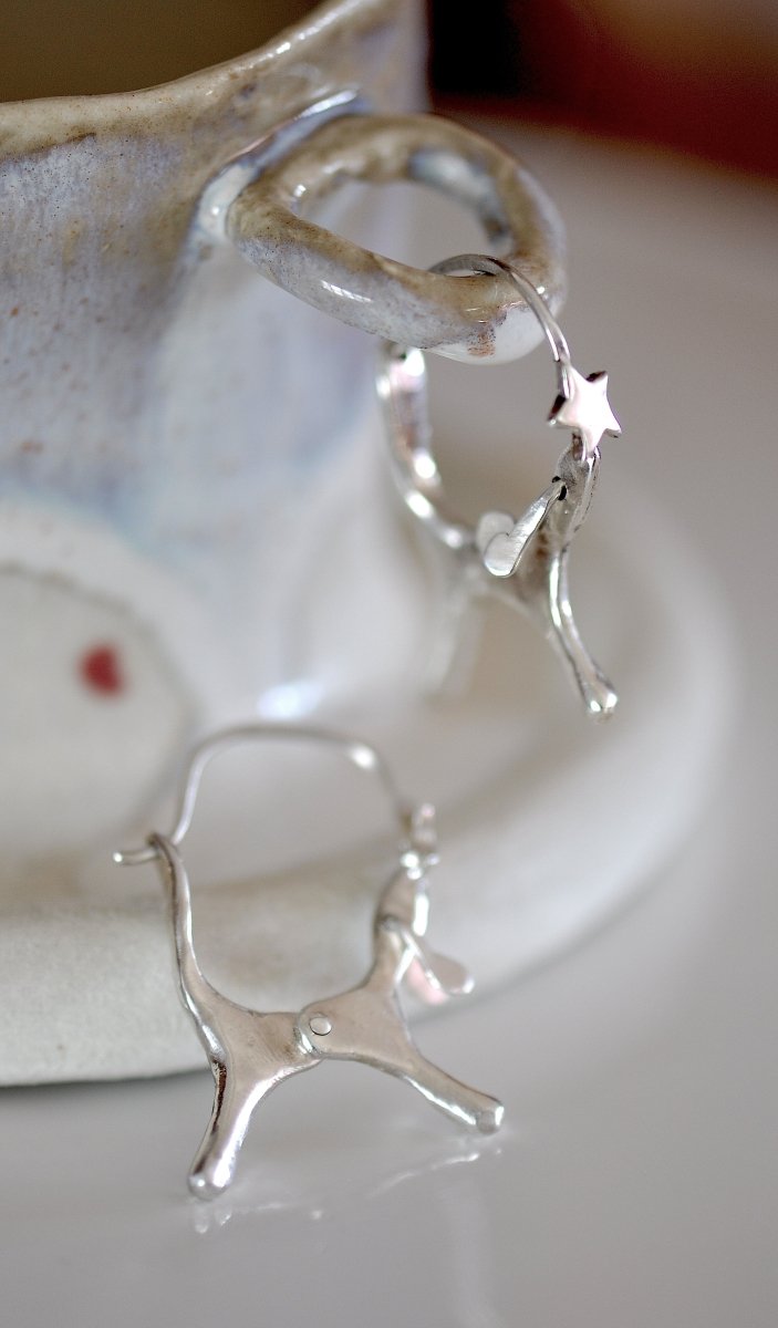 Handmade sterling silver dog shaped hoop earrings with articulated moving ears, made in Barcelona