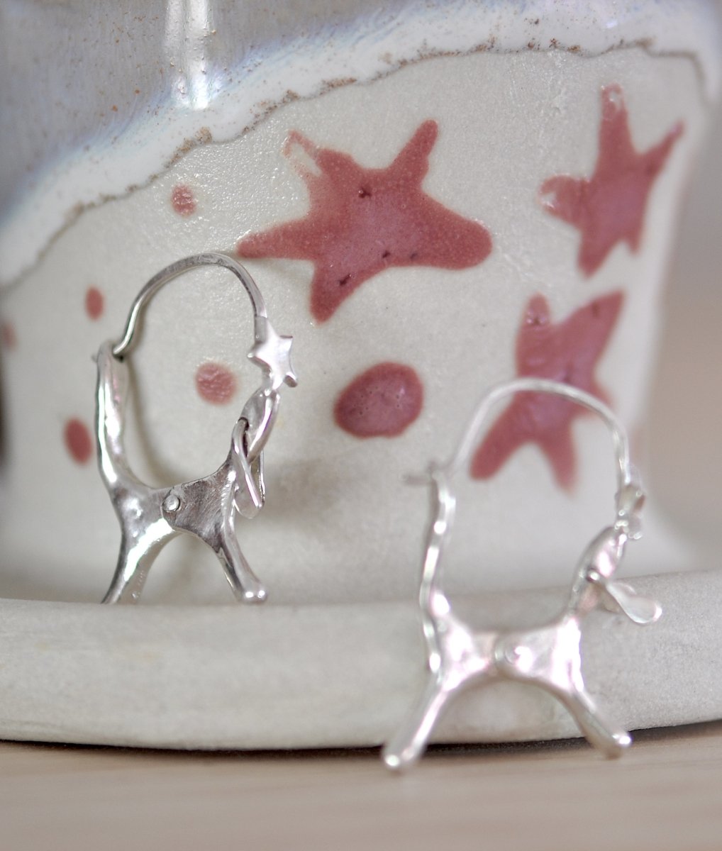 Handmade sterling silver dog shaped hoop earrings with articulated moving ears, made in Barcelona
