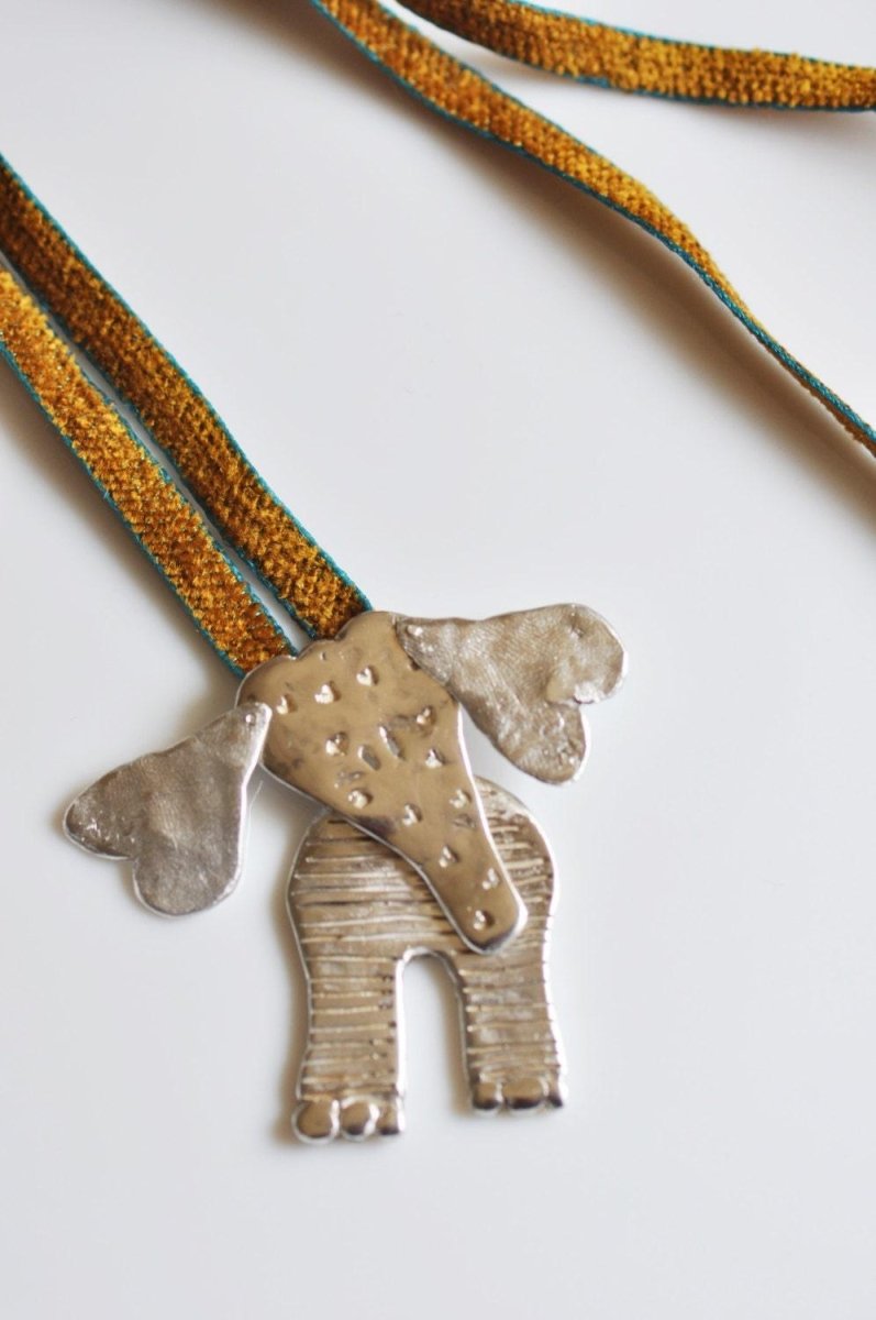 Handmade sterling silver articulated elephant necklace with textured sculptural design, whimsical animal jewelry