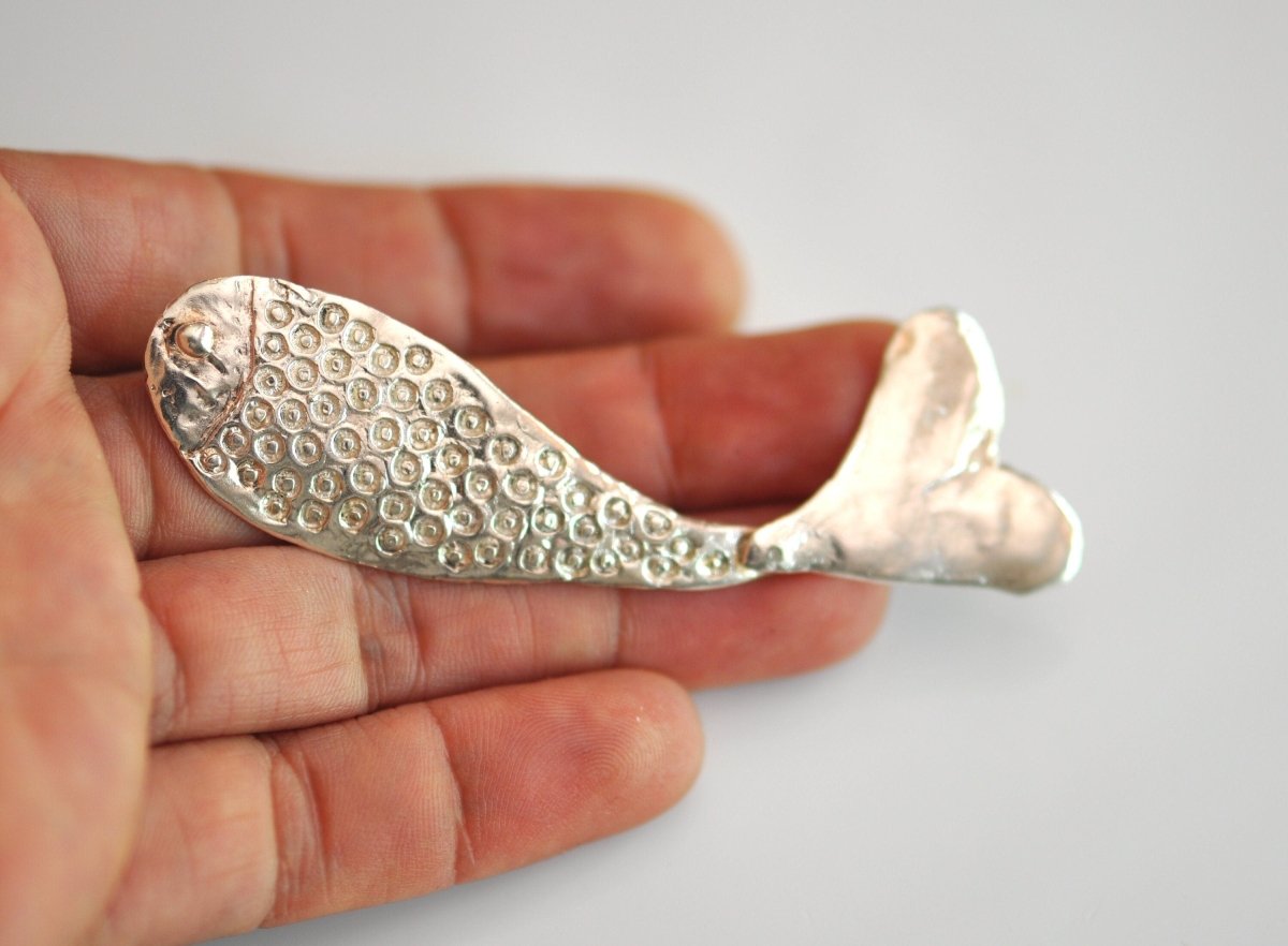 Handmade sterling silver articulated fish brooch with detailed scales and fins, whimsical nature jewelry