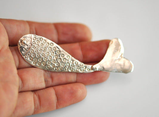 Handmade sterling silver articulated fish brooch with detailed scales and fins, whimsical nature jewelry