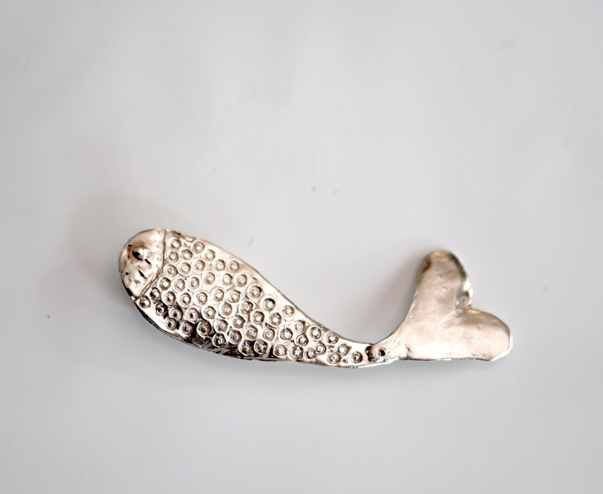 a metal object on a white surface