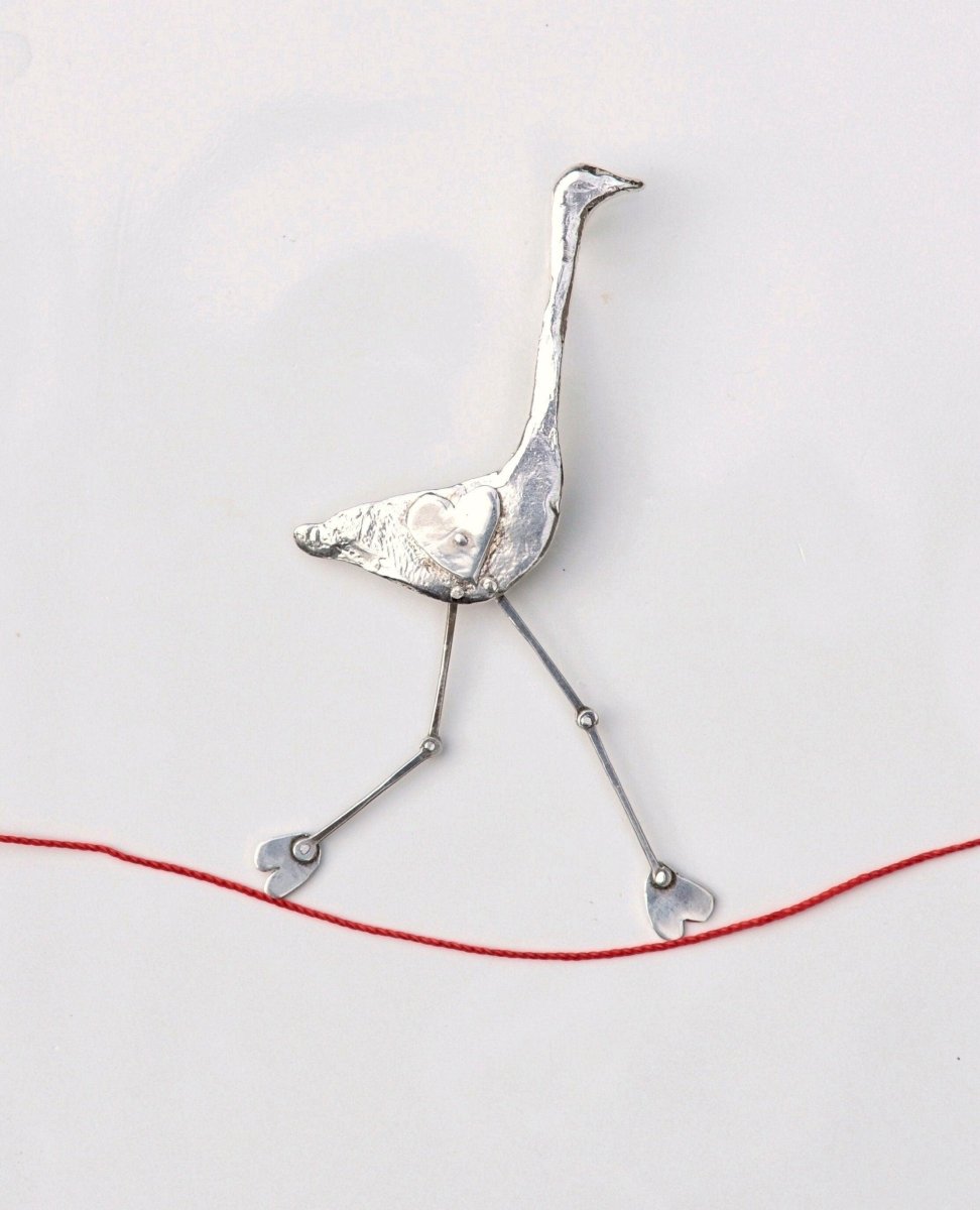 Handmade sterling silver articulated crane brooch with long legs on red cord, whimsical sculptural bird jewelry