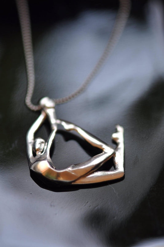 Handmade sterling silver swimmer pendant necklace with sculptural female figure in motion, wearable sculpture jewelry