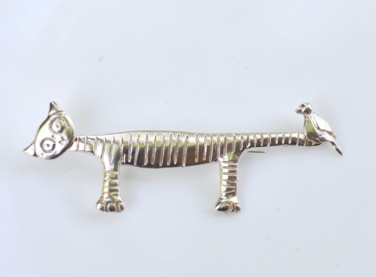 Handmade sterling silver quirky cat and bird brooch with striped cat and perched bird on tail, whimsical animal jewelry