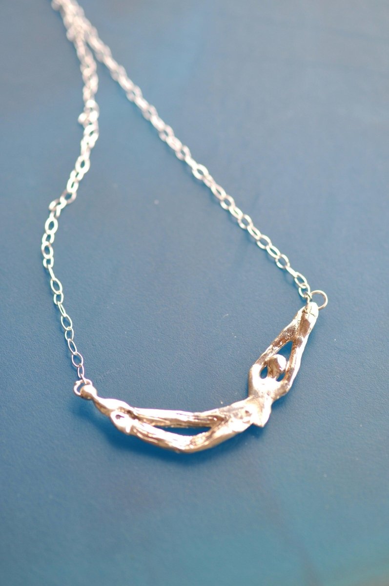 back of clown in silver necklace 