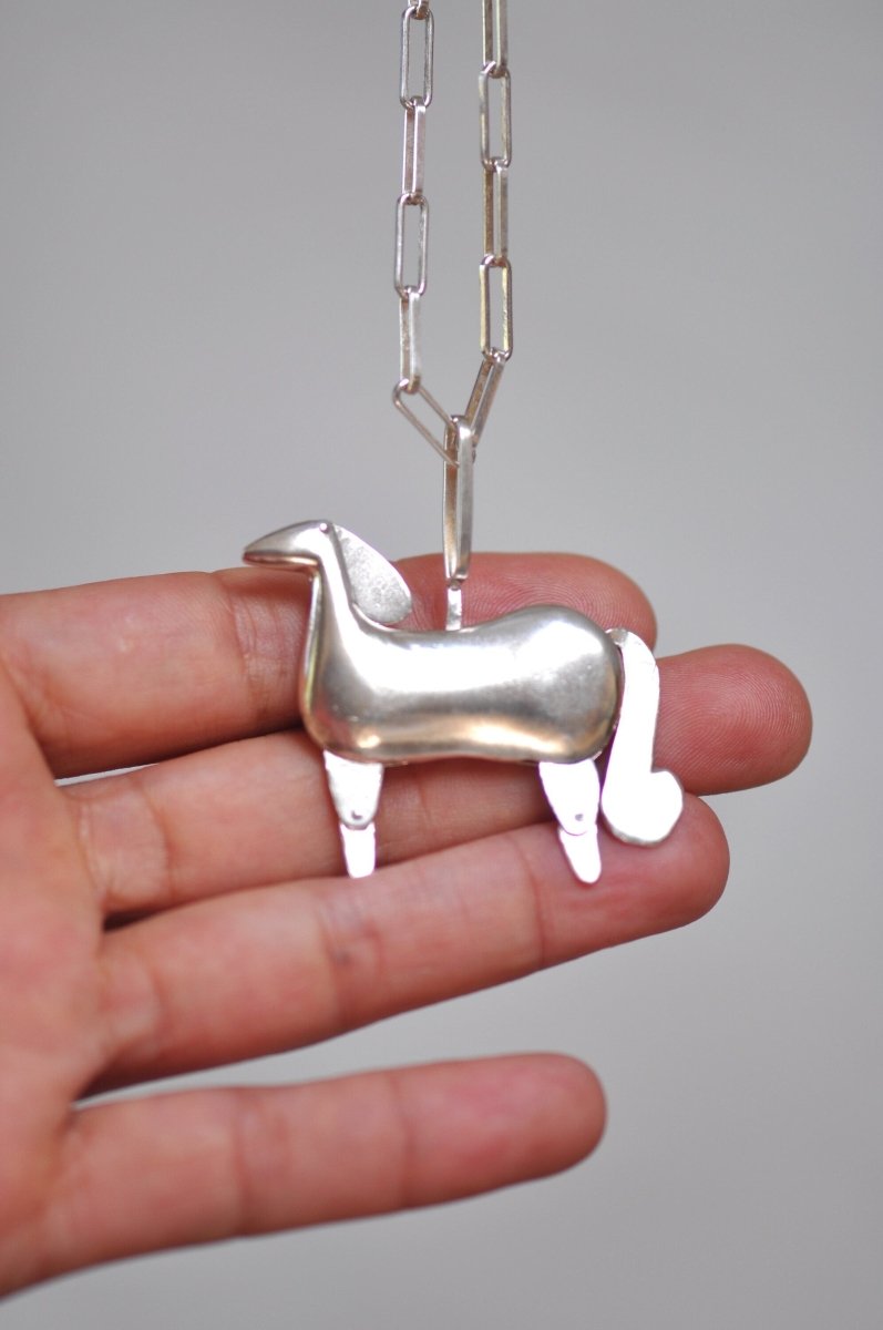 Handmade sterling silver articulated horse pendant necklace with sculptural body and articulated legs, made in Barcelona