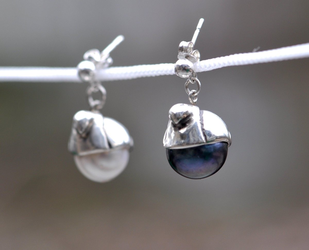 Handmade sterling silver bird earrings cradling white and black freshwater pearls, unique pearl bird jewelry