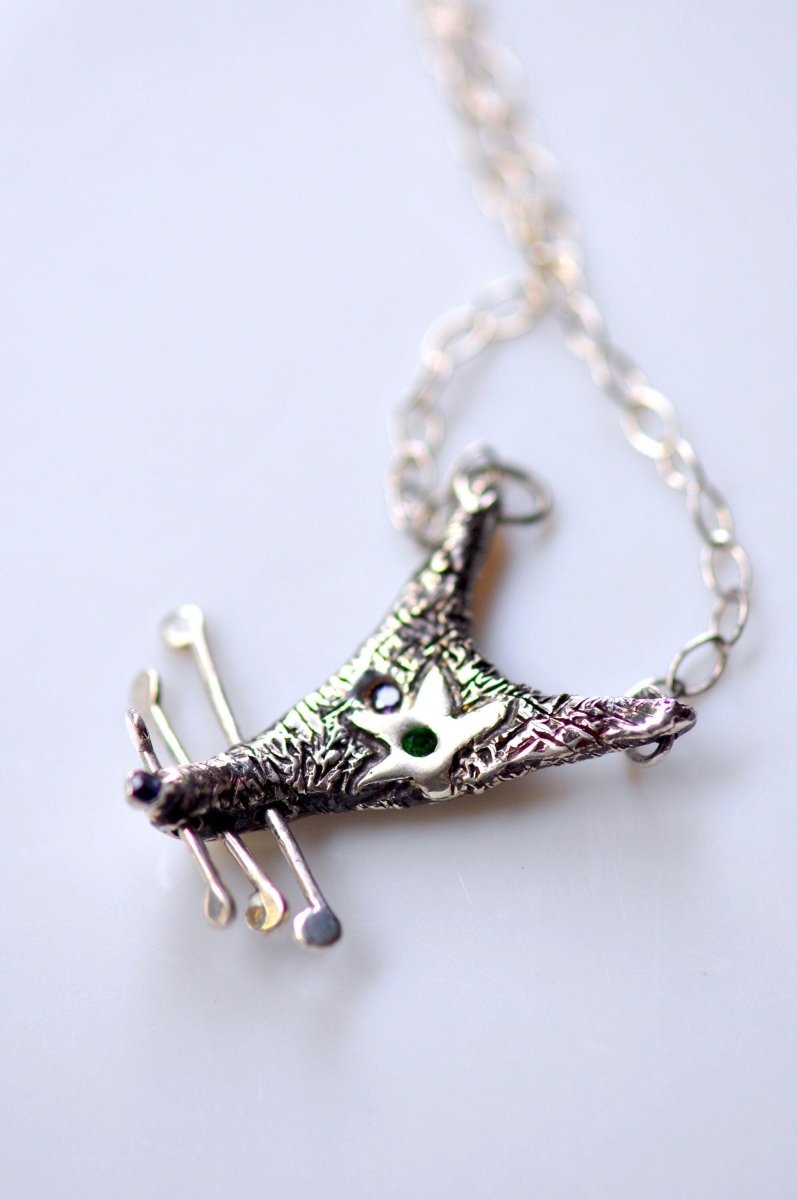 Handmade sterling silver rat charm necklace with black patina and silver star eye detail, quirky whimsical animal jewelry