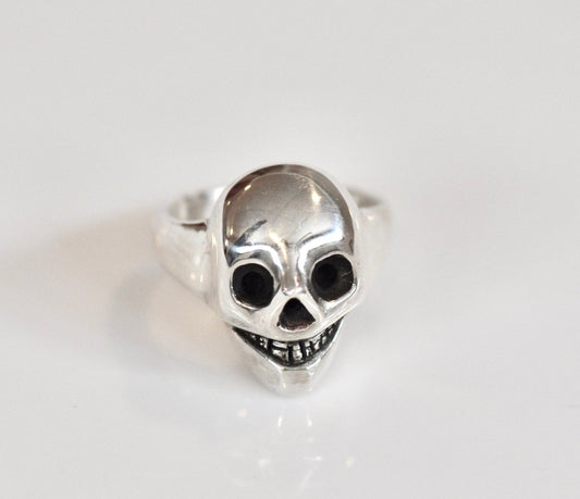 Handmade sterling silver grinning skull ring with polished finish and dark eye sockets, statement ring, made in Barcelona